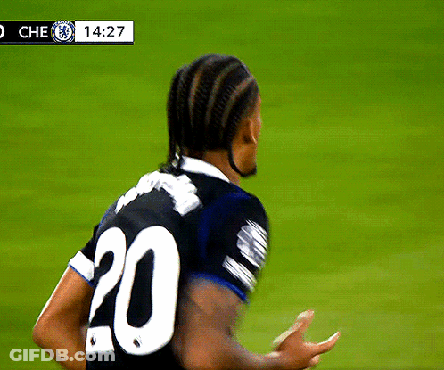 A Soccer Player Wearing A Black Jersey With The Number 20 On The Back GIF
