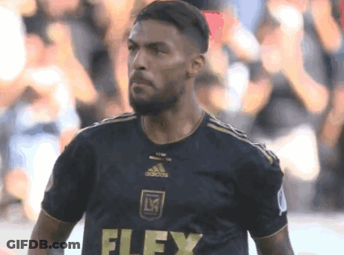 A Soccer Player Wearing A Black Jersey With The Word Flex On The Front GIF