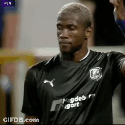 A Soccer Player Wearing A Black Shirt That Says Magdeborg On It GIF