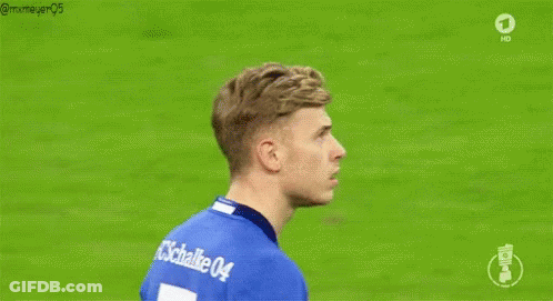 A Soccer Player Wearing A Blue Adidas Shirt Is Standing On A Soccer Field . GIF