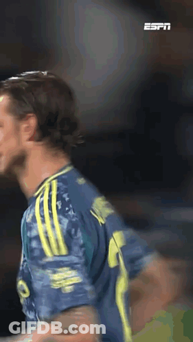 A Soccer Player Wearing A Blue And Yellow Jersey With The Number 9 On It GIF