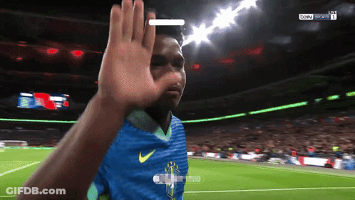 A Soccer Player Wearing A Blue Nike Jersey Is Waving At The Camera GIF