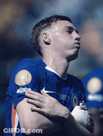 A Soccer Player Wearing A Blue Shirt With A Fifa Logo On It GIF