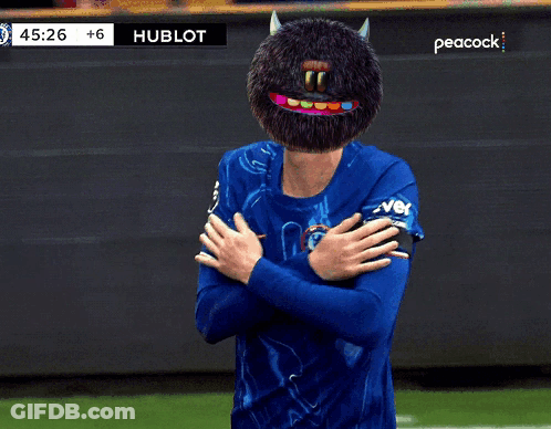 A Soccer Player Wearing A Blue Shirt With A Peacock Logo On The Bottom GIF