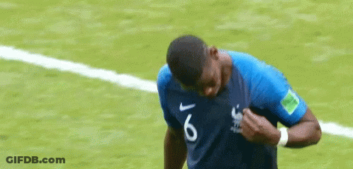 A Soccer Player Wearing A Blue Shirt With The Number 6 On It Is Standing On A Soccer Field . GIF