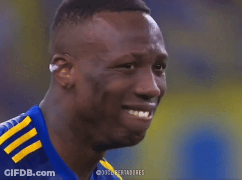 A Soccer Player Wearing A Blue Shirt With Yellow Stripes On The Sleeves GIF