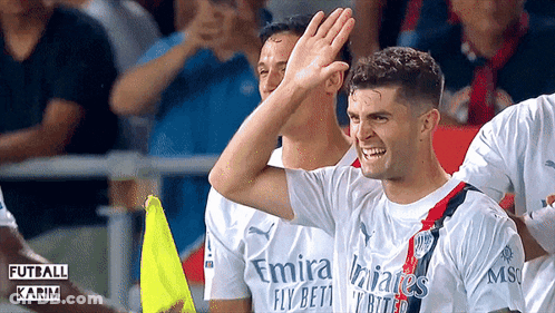 A Soccer Player Wearing A Fly Emirates Jersey High Fives His Teammates GIF