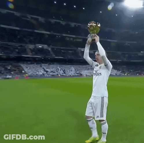 A Soccer Player Wearing A Fly Emirates Jersey Holds A Trophy In His Hand GIF