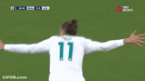 A Soccer Player Wearing A Fly Emirates Jersey Is Celebrating GIF