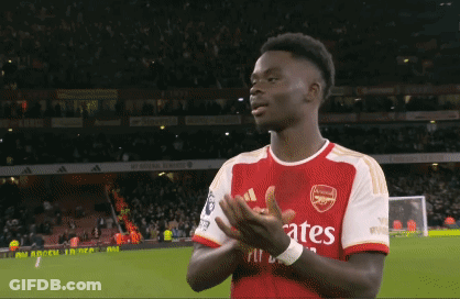 A Soccer Player Wearing A Fly Emirates Jersey Is Clapping GIF