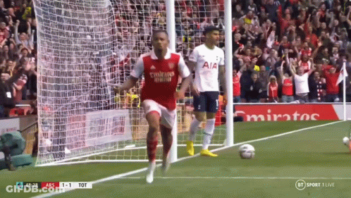 A Soccer Player Wearing A Fly Emirates Shirt Is Running Towards The Goal GIF