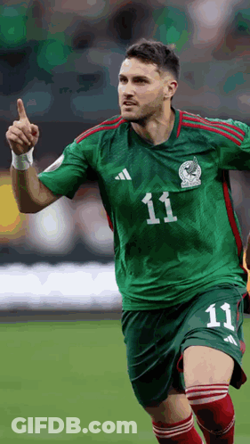 A Soccer Player Wearing A Green And Red Jersey With The Number 11 On It GIF