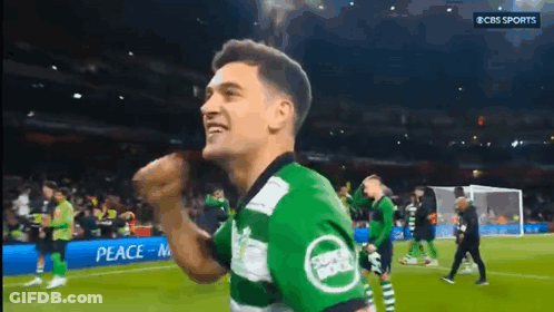 A Soccer Player Wearing A Green And White Jersey With The Word Sports On It GIF