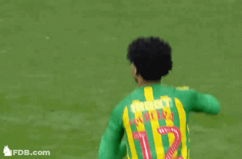 A Soccer Player Wearing A Green And Yellow Jersey With The Number 1 GIF