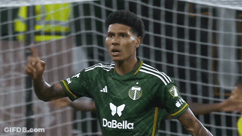 A Soccer Player Wearing A Green Dabella Jersey Celebrates GIF