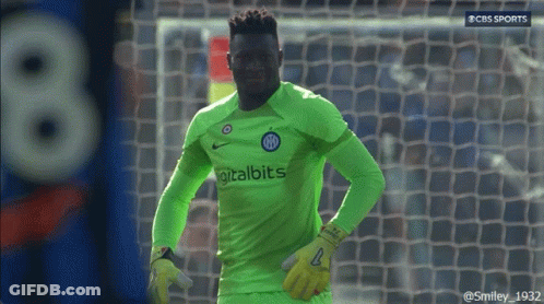 A Soccer Player Wearing A Green Digitalbits Jersey Stands In Front Of A Goal GIF