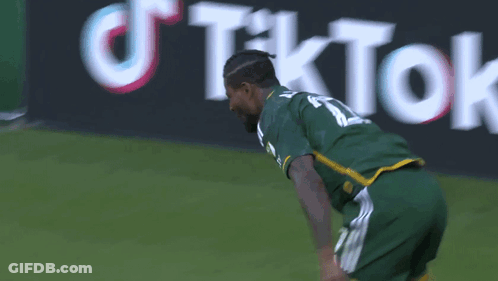 A Soccer Player Wearing A Green Jersey With The Number 11 On It GIF