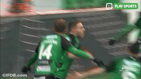 A Soccer Player Wearing A Green Jersey With The Number 4 On It GIF