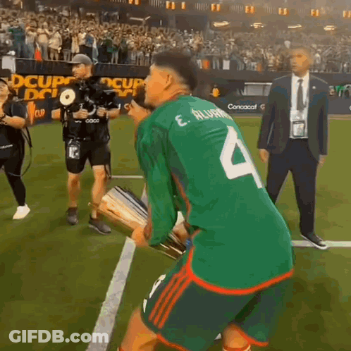 A Soccer Player Wearing A Green Jersey With The Number 4 On The Back GIF