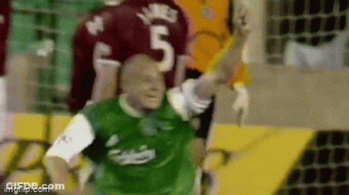 A Soccer Player Wearing A Green Jersey With The Number 5 On It GIF