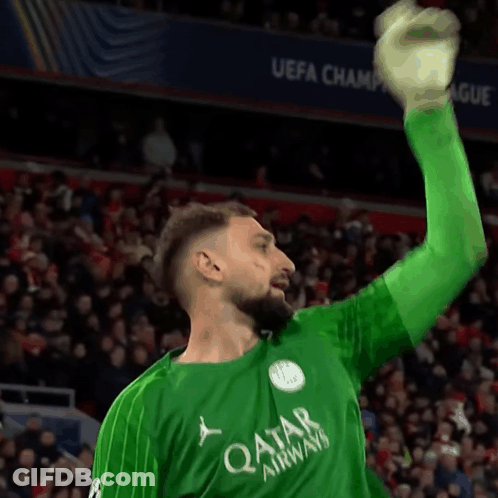 A Soccer Player Wearing A Green Qatar Airways Jersey Raises His Arm In The Air GIF