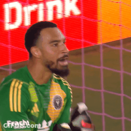 A Soccer Player Wearing A Green Shirt With Frachi On The Sleeves GIF