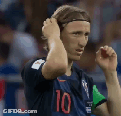 A Soccer Player Wearing A Headband Is Adjusting His Hair While Standing On The Field . GIF
