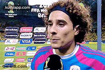 A Soccer Player Wearing A Headband Is Talking Into A Microphone On A Soccer Field GIF