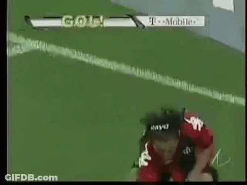 A Soccer Player Wearing A Helmet Is Kneeling On The Field With A T-Mobile Ad In The Background GIF