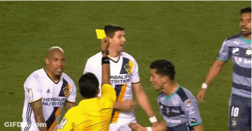 A Soccer Player Wearing A Herbalife Nutrition Jersey Is Being Given A Yellow Card GIF