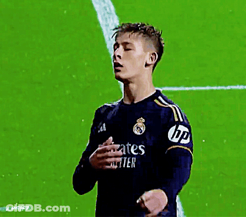 A Soccer Player Wearing A Jersey That Says Emirates Fly Better Holds His Hand To His Chest GIF