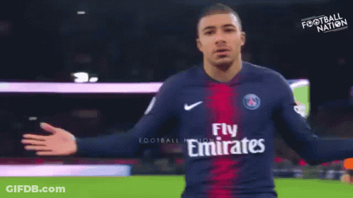 A Soccer Player Wearing A Jersey That Says Fly Emirates On It GIF