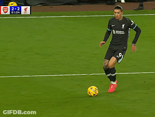 A Soccer Player Wearing A Jersey That Says Standard Chartered Is Kicking The Ball GIF