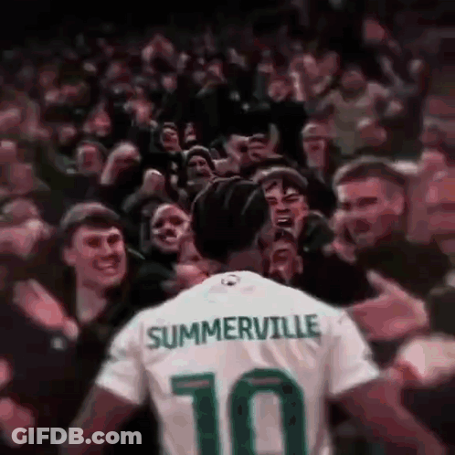 A Soccer Player Wearing A Jersey With The Number 10 On It Is Surrounded By Fans . GIF