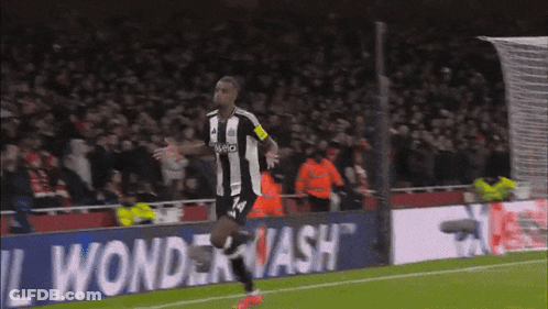 A Soccer Player Wearing A Jersey With The Number 14 Is Running On The Field GIF