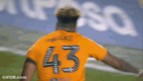 A Soccer Player Wearing A Jersey With The Number 43 On It Is Walking On The Field . GIF