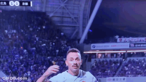 A Soccer Player Wearing A Kyocera Jersey Celebrates GIF
