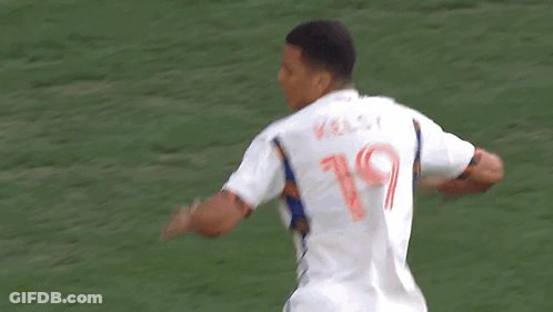 A Soccer Player Wearing A Mercy Health Jersey Is Being Congratulated By His Teammate GIF