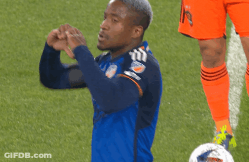 A Soccer Player Wearing A Mercy Health Jersey Makes A Heart Shape With His Hands GIF