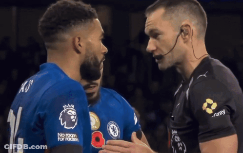 A Soccer Player Wearing A No Room For Racism Shirt Is Talking To Another Player GIF