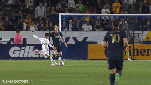 A Soccer Player Wearing A Number 10 Jersey Is Kicking The Ball GIF