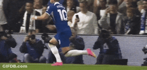 A Soccer Player Wearing A Number 10 Jersey Is Running On The Field GIF
