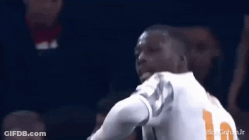 A Soccer Player Wearing A Number 11 Jersey Is Standing In Front Of A Crowd . GIF