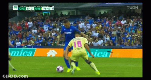 A Soccer Player Wearing A Number 18 Jersey Is Being Tackled GIF