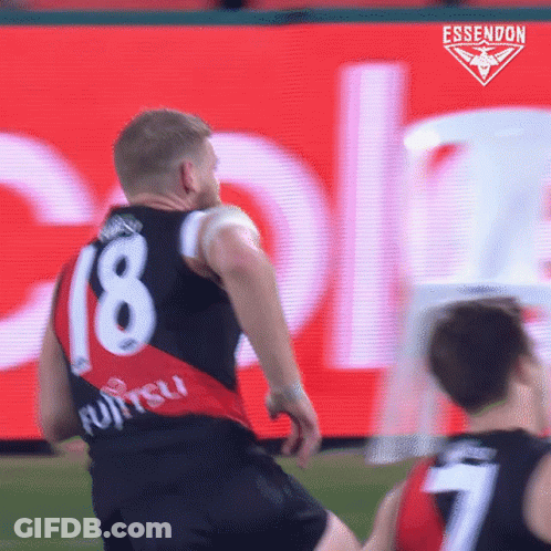 A Soccer Player Wearing A Number 18 Jersey Is Kicking The Ball GIF
