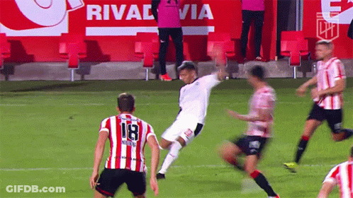 A Soccer Player Wearing A Number 18 Jersey Kicks The Ball GIF