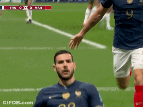 A Soccer Player Wearing A Number 22 Jersey Is Being Tackled By Another Player GIF