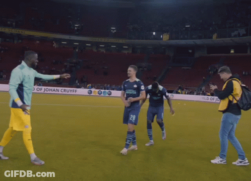 A Soccer Player Wearing A Number 28 Jersey Is Hugging Another Player GIF
