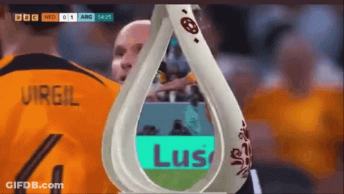 A Soccer Player Wearing A Number 4 Jersey Stands Next To A Trophy GIF