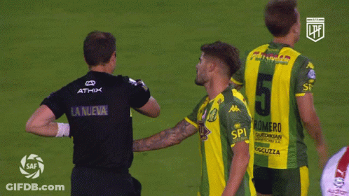 A Soccer Player Wearing A Number 5 Jersey Talks To Another Player GIF